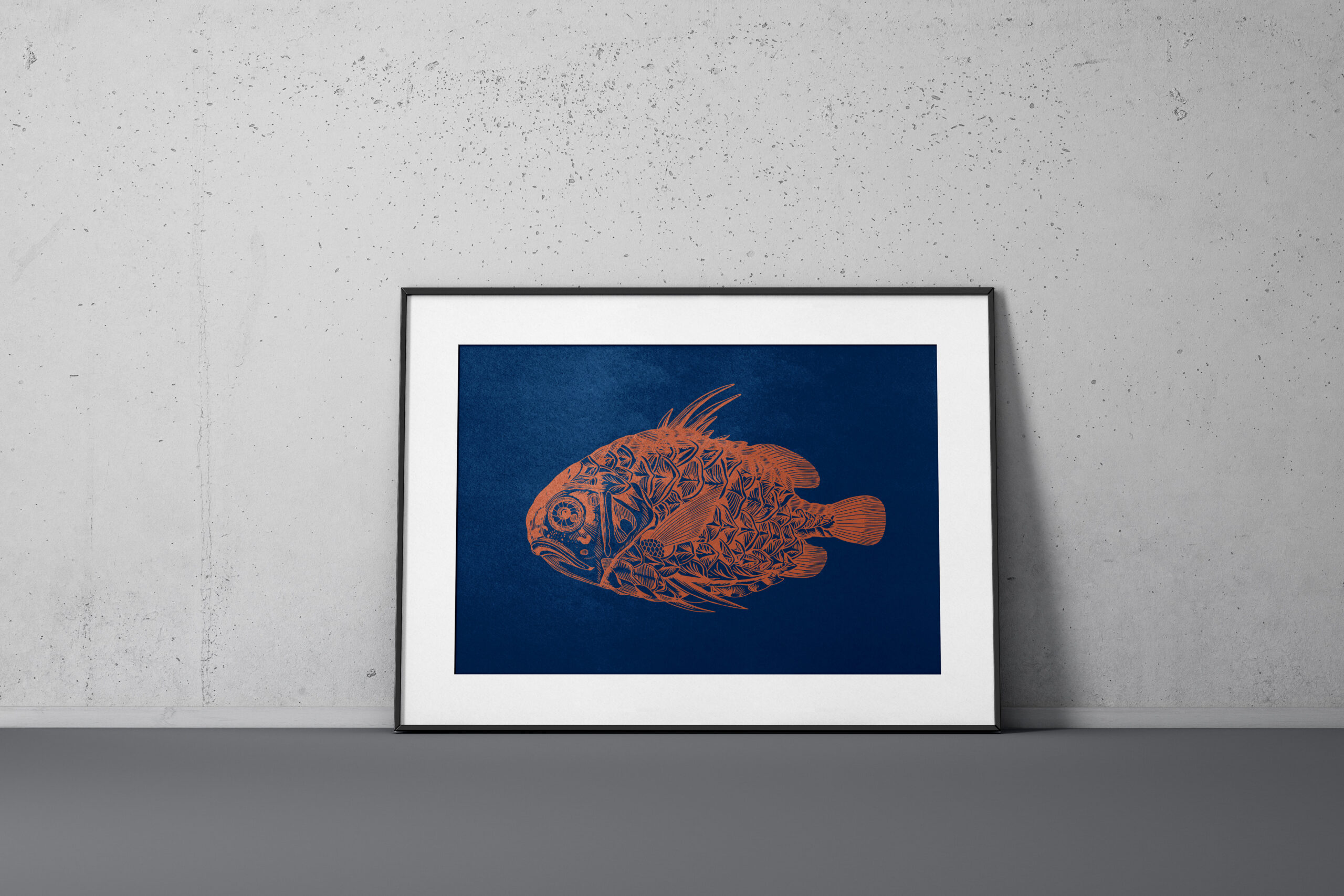 Kunstdruck im Querformat eines Fisches in Kupfer auf dunkel blauen Papier im Bilderrahmen vor einer grauen Wand.
